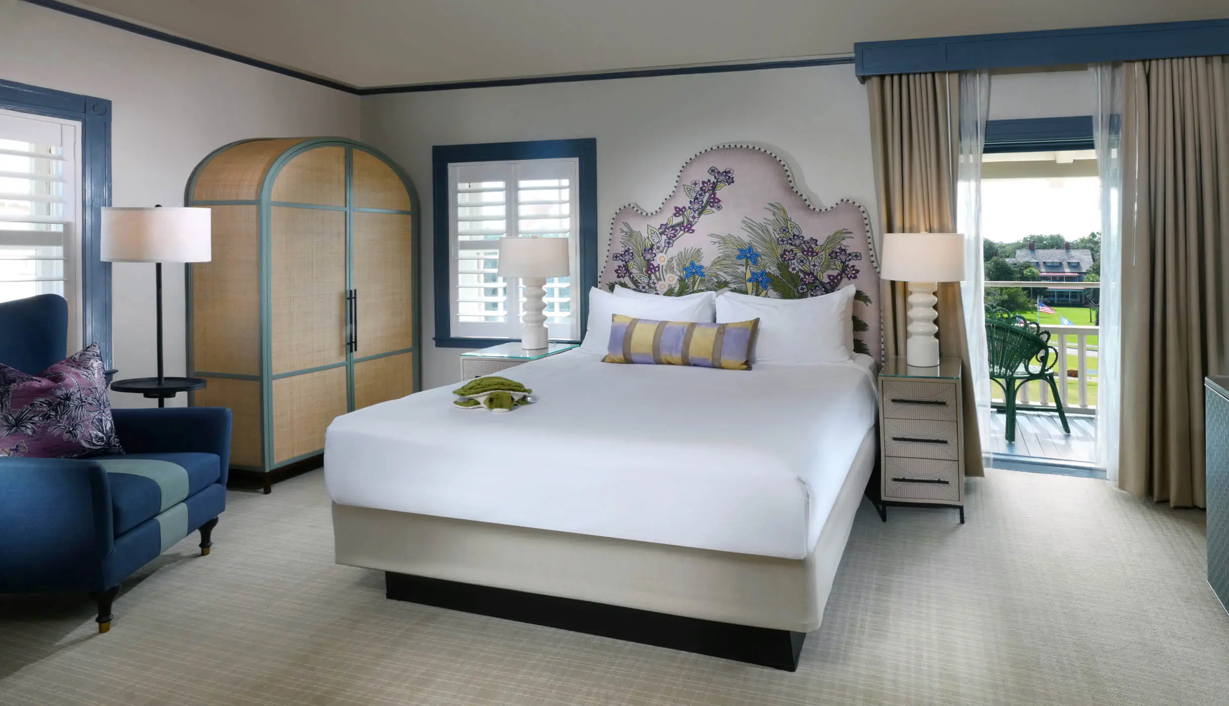 A queen bed in a room with access to a balcony
