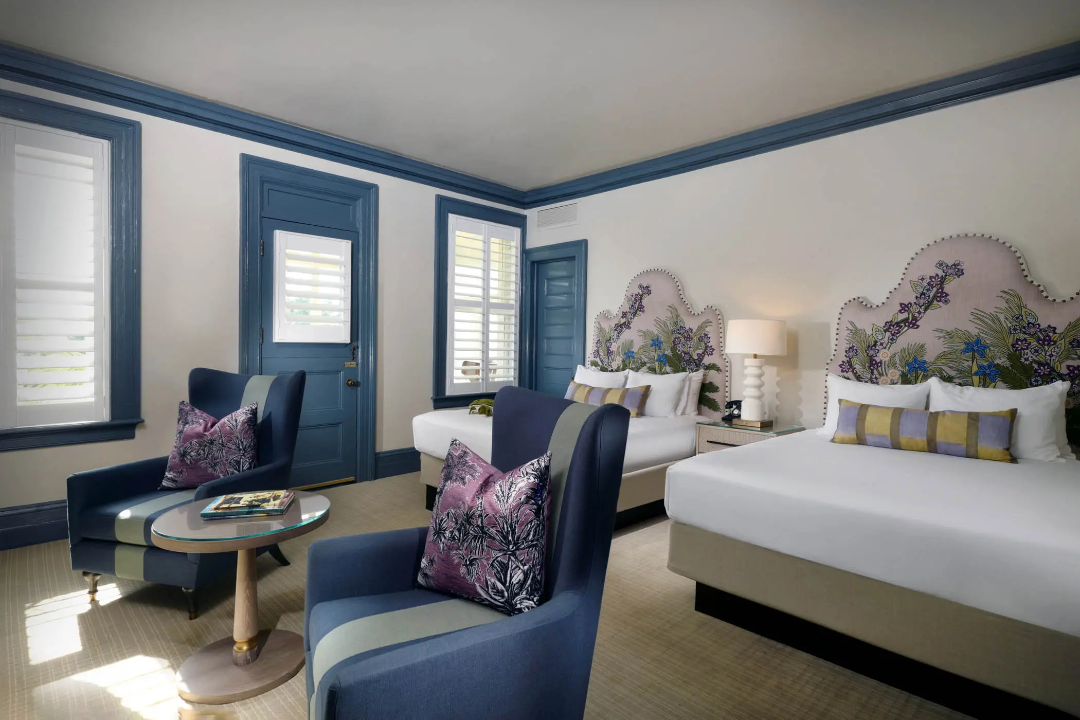 Deluxe Double Queen Clubhouse room with 2 lounge chair and access to a patio
