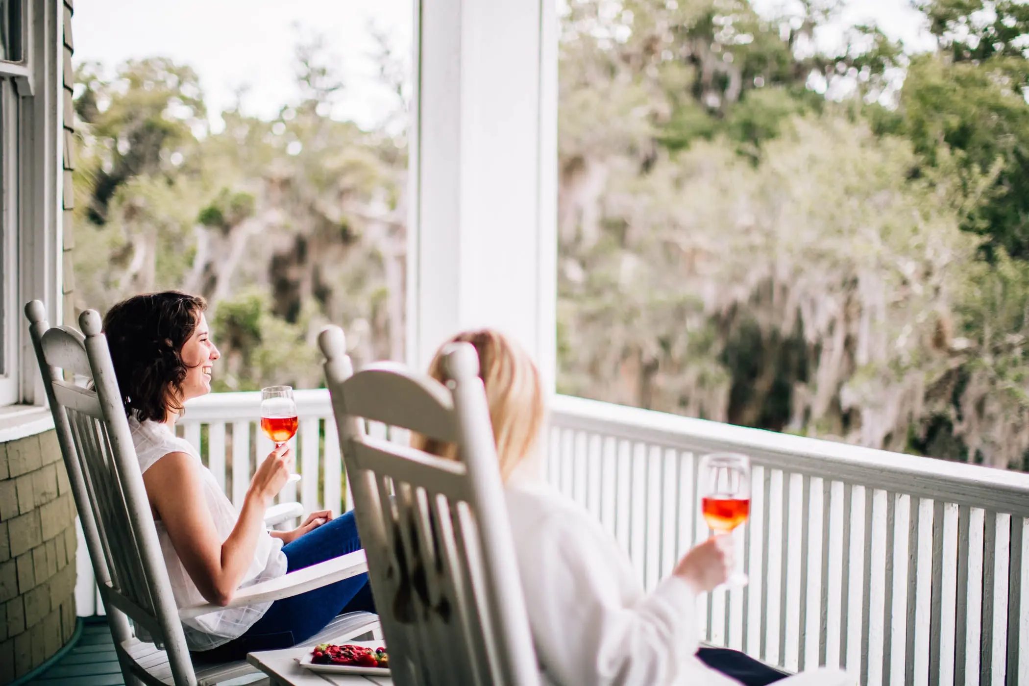 Two women sitting on the deck of Jekyll drinking wine